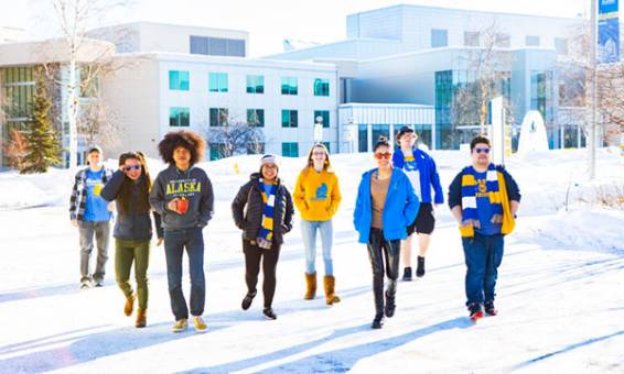 UAF Student Ambassadors walk through Cornerstone Plaza on a winter day