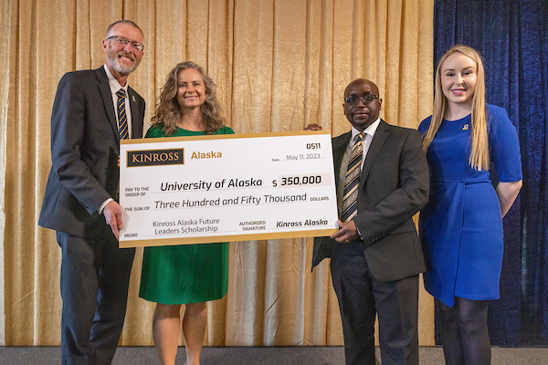 UAF Chancellor Dan White, Kinross Gold Corporation Director of External Affairs U.S. Anna Atchison, Kinross Alaska Vice President and General Manager Terence Watungwa, and Kinross Alaska Communications Specialist Brenna Schaake display a check to University of Alaska for $350,000 donated by Kinross Alaska for the new Kinross Alaska Future Leaders Scholarship during the Blue & Gold Celebration at Dine 49 in the Wood Center on the UAF campus Thursday evening, May 11, 2023.