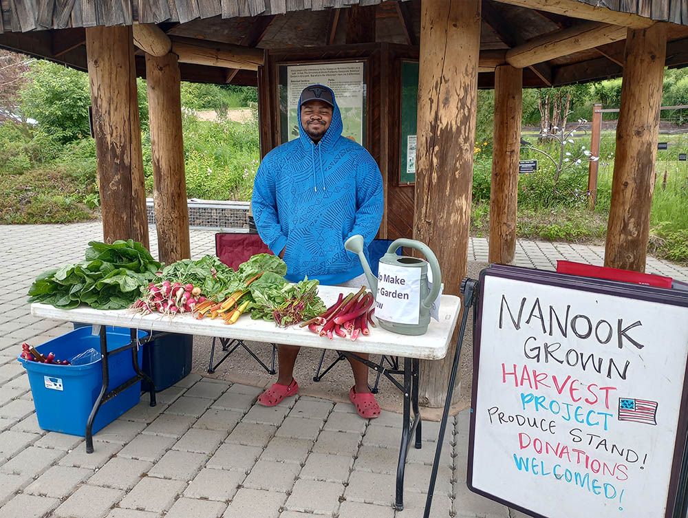 Man standing behind Nanook Grown booth table
