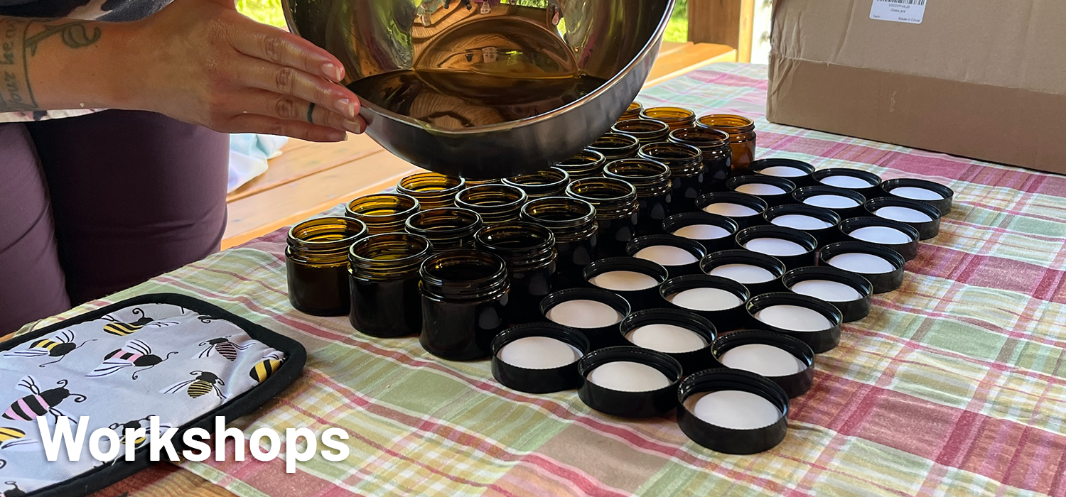 Lip Balm workshop photo. Workshop host pouring lip balm oils into jars.