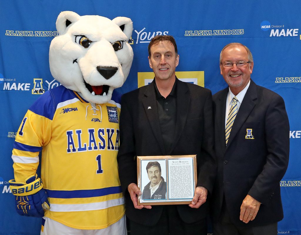 UAF mascot Nanook and athletic Director Gary Gray pose with Scott Roselius, center, during his induction into the Nanook Hall of Fame in 2016, when was given the Alumni Achievement Award for Community Support.