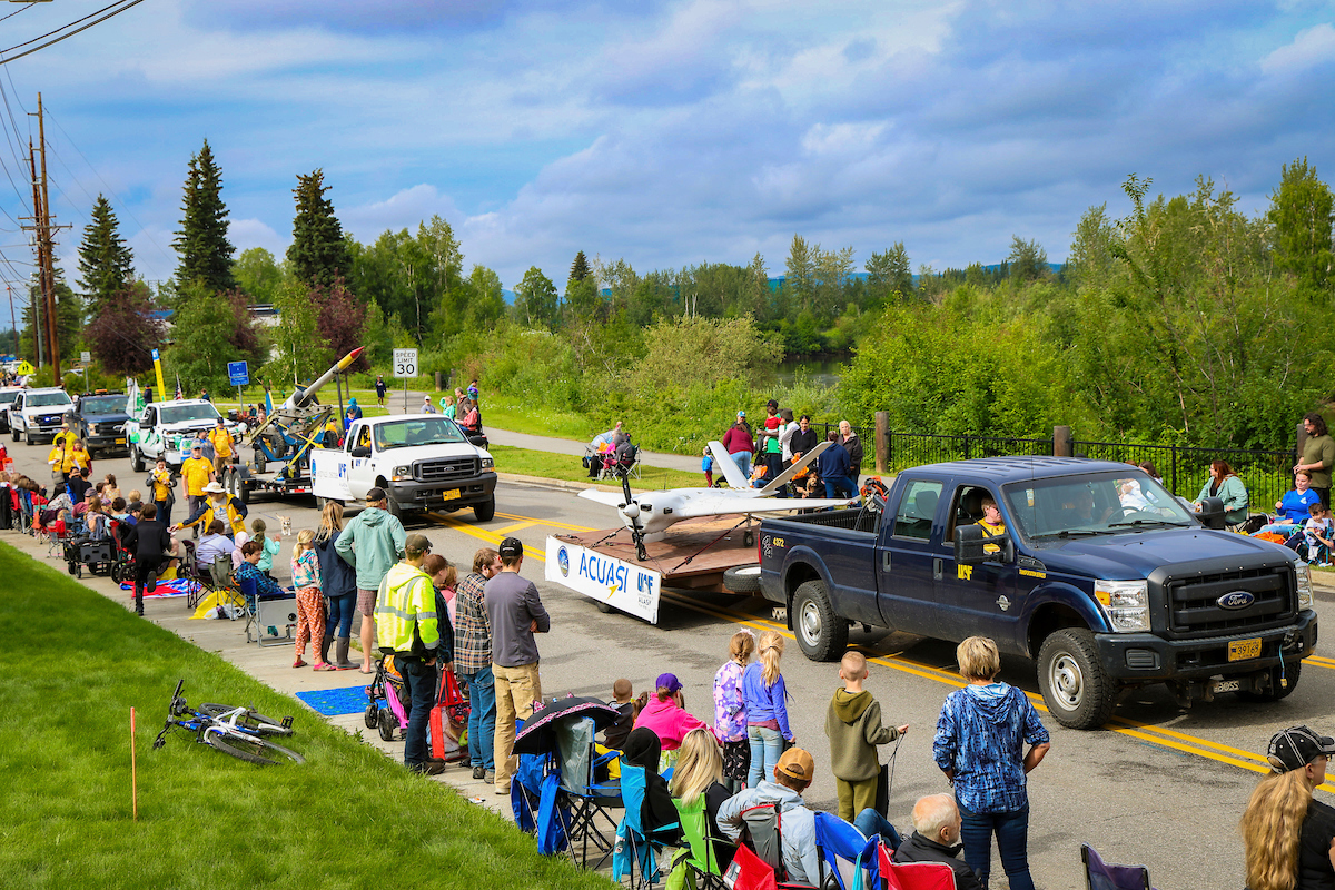 An unmanned drone is pulled through the streets of downtown Fairbanks by members of the Alaska Center for Unmanned Aircraft System Integration (ACUASI) as part of Nanook Nation in the 2023 Golden Days Parade.