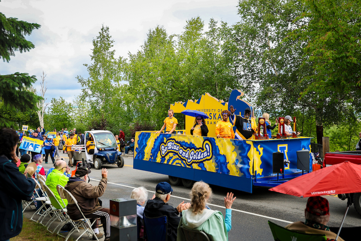 UAF staff and alum wave to the crowd from the Nanook Nation float during the 2023 Golden Days Parade in downtown Fairbanks.