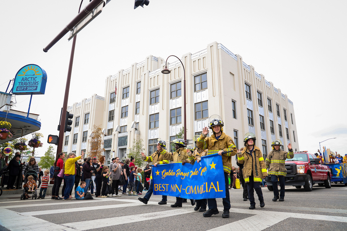 Students of the UAF CTC Fire Science Academy lead the Nanook Nation troop as they walk down the streets of downtown Fairbanks holding the sign for 'Best Non-Commercial' float at the 2023 Golden Days Parade.