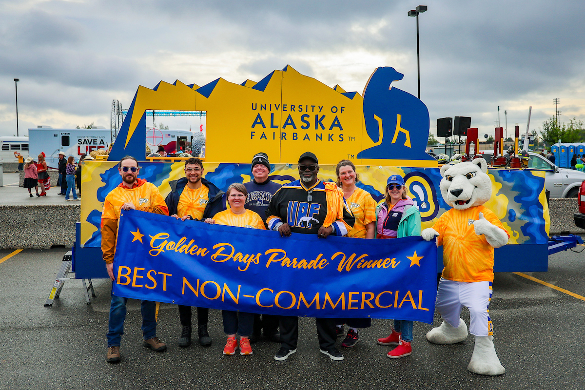 Left to right, Adam Rubin, Kyle Agustines, Felicia Burud, Alan Mitchell, Darryl Lewis Sr., Theresa Bakker, Kara Nash and Nook, take a photo in front the 2023 Golden Days Parade float after winning the award for 'Best Non-Commercial' float. 