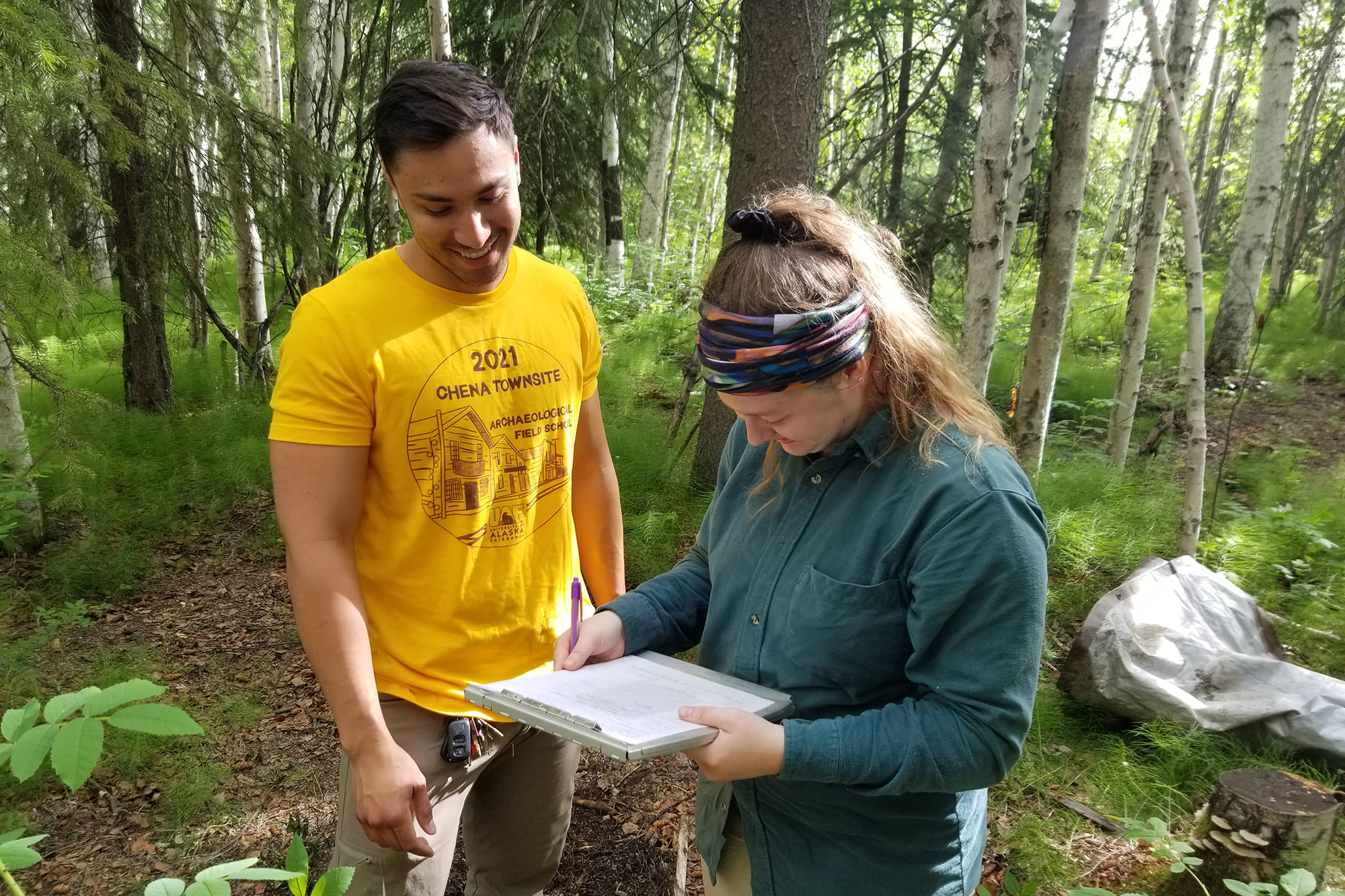 Two students reading a form at the Chena Townsite field school