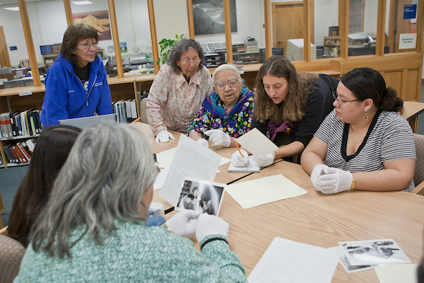 Staff members with the Alaska and Polar Regions Collection at the Rasmuson Library work with elders from the Koyukuk River villages of Huslia, Hughes and Allakaket identifying subjects in old photos recently added to the library's collection.