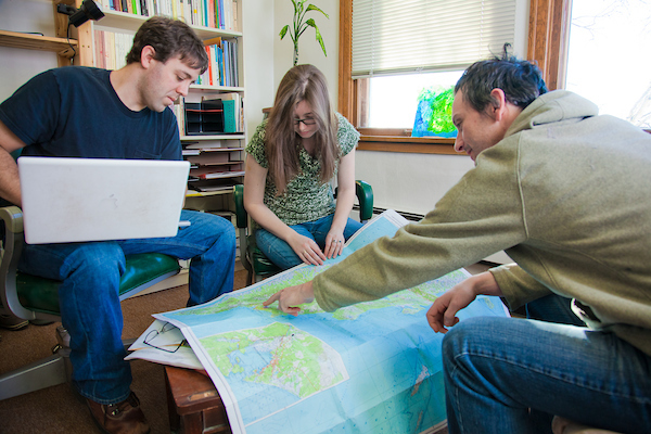 Graduate students Gerad Smith, left, and Nickole Robarge meet with anthropology faculty member Patrick Plattet in his Eielson Building office. | UAF Photo by Todd Paris