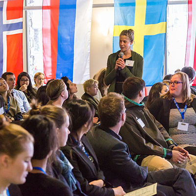 A speaker addresses a room of Model Arctic Council participants | UAF Photo