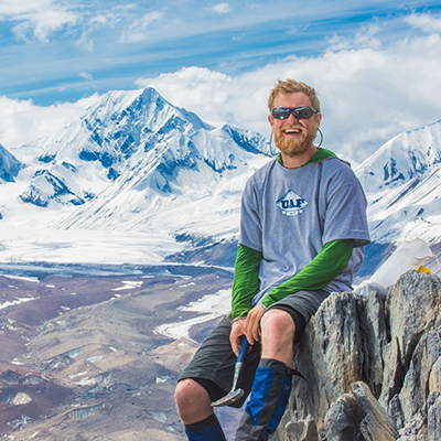 Undergraduate geology major Pat Terhune poses near his camp above the Chedotlothna Glacier on June 28 during a 15-day field trip researching complexities of the Denali fault in Denali National Park and Preserve. | UAF Photo by Todd Paris