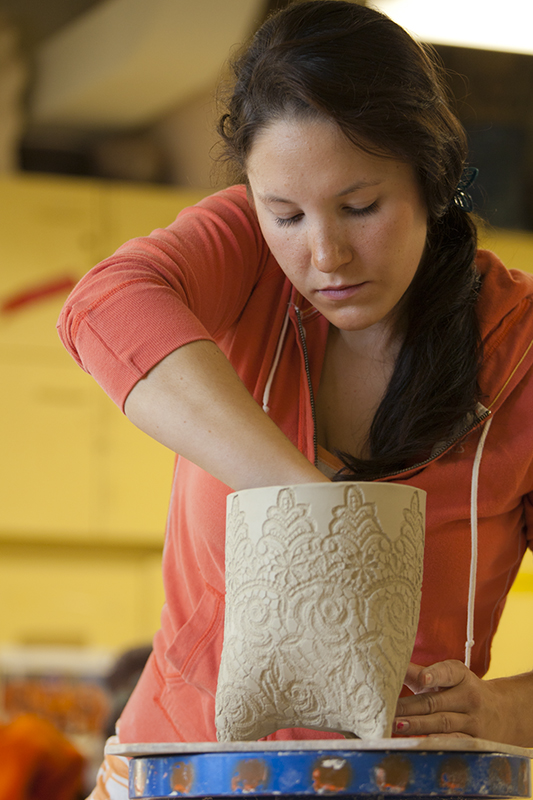 Holly Feder puts some finishing touches on a project in her summer sessions ceramics class in the UAF Fine Arts Complex. | UAF Photo by Todd Paris
