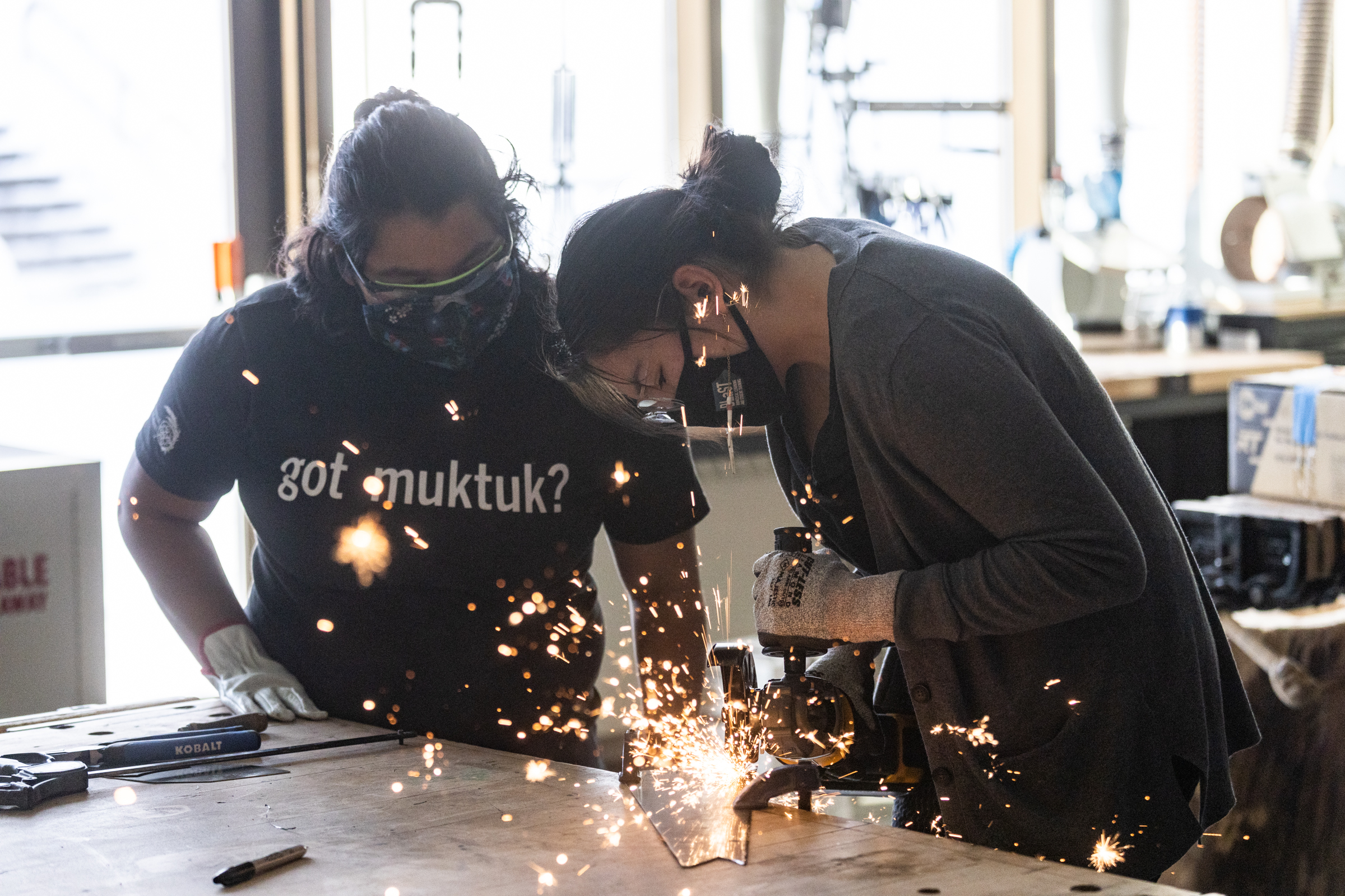 Sparks fly as two student grind metal in the Native Arts Studio | UAF Photo by JR Ancheta