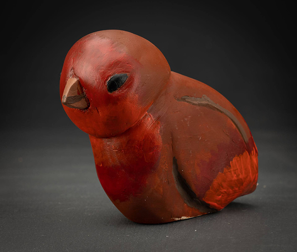A small red carved bird