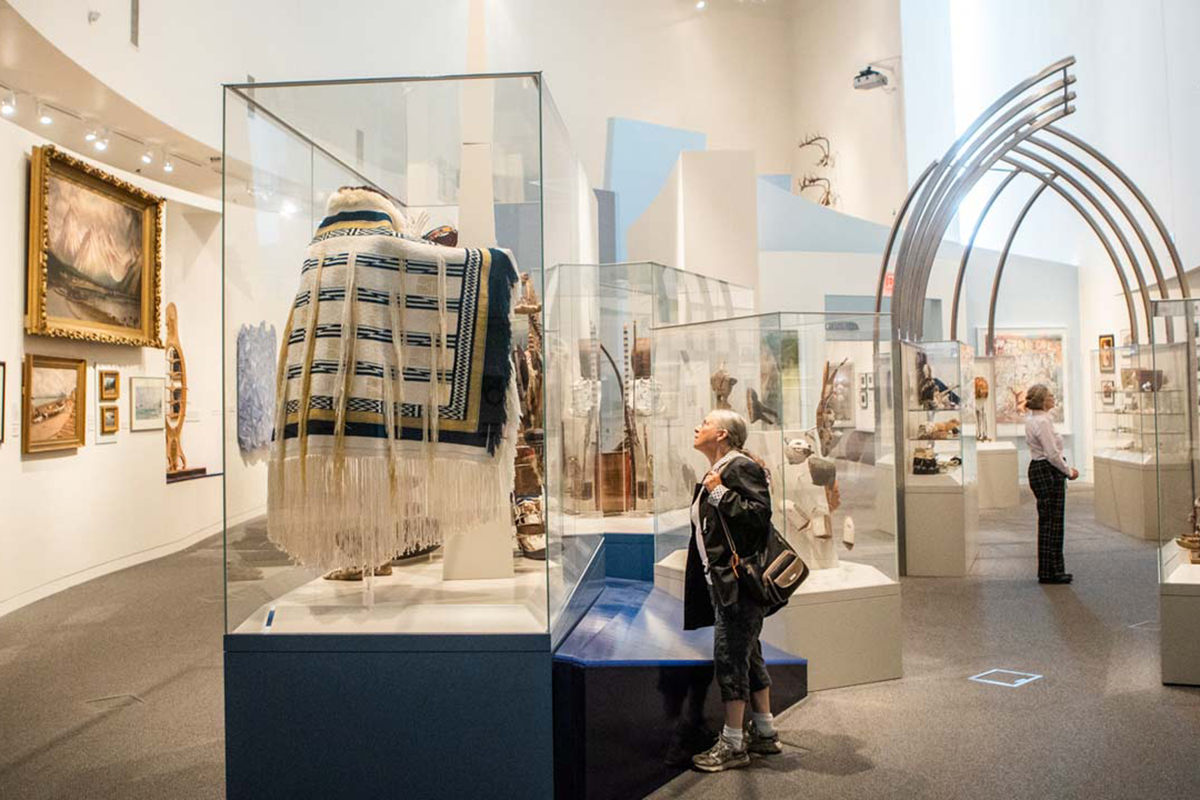 A UAMN visitor examines objects on display in the Rose Berry Alaska Art Gallery. UAF Photo