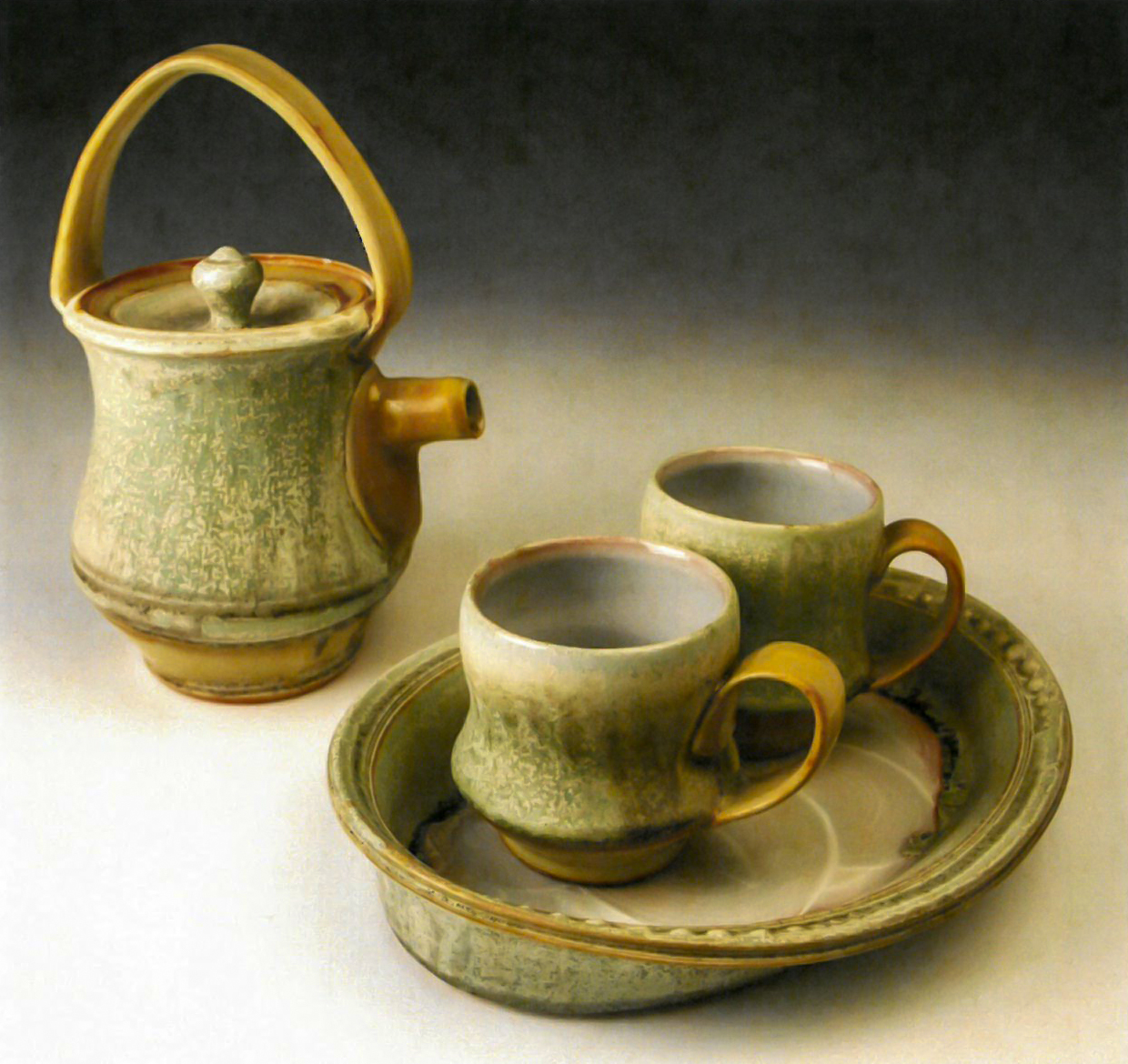 Ceramic teapot with two mugs on a tray