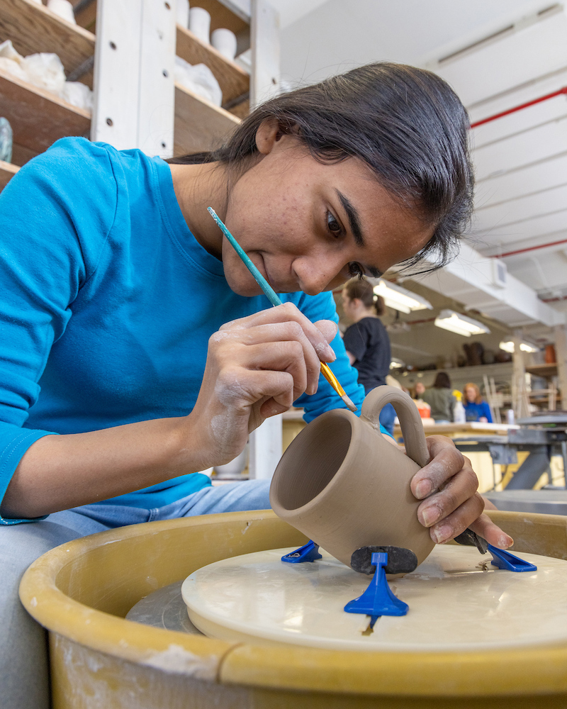 Shambhavi Garg works in the ceramics studio in the Fine Arts Complex on the UAF campus Wednesday, March 22, 2023. | UAF Photo by Eric Engman