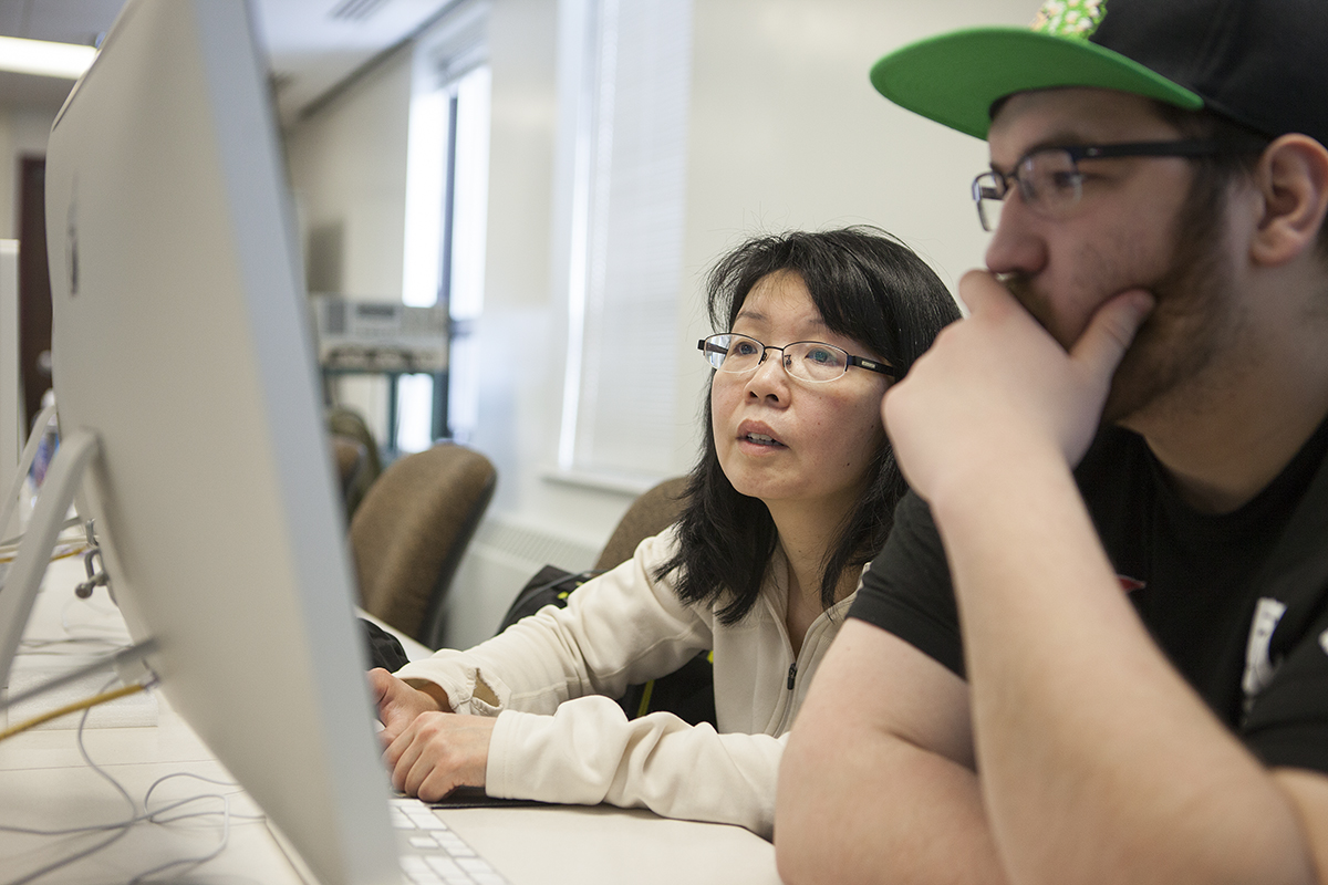 Miho Aoki helps a student in the Bunnell computer lab