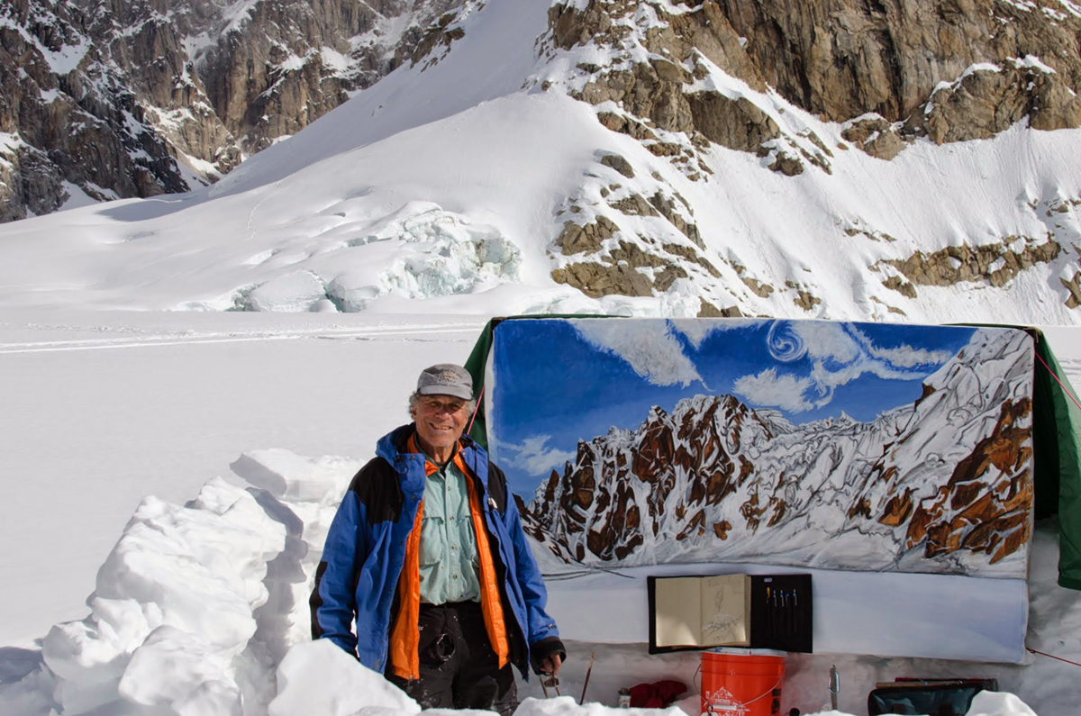 Bill Brody in front of a painting of the Rooster Comb in the west fork of the Ruth Glacier in Denali National Park. Photo courtesy of Brody