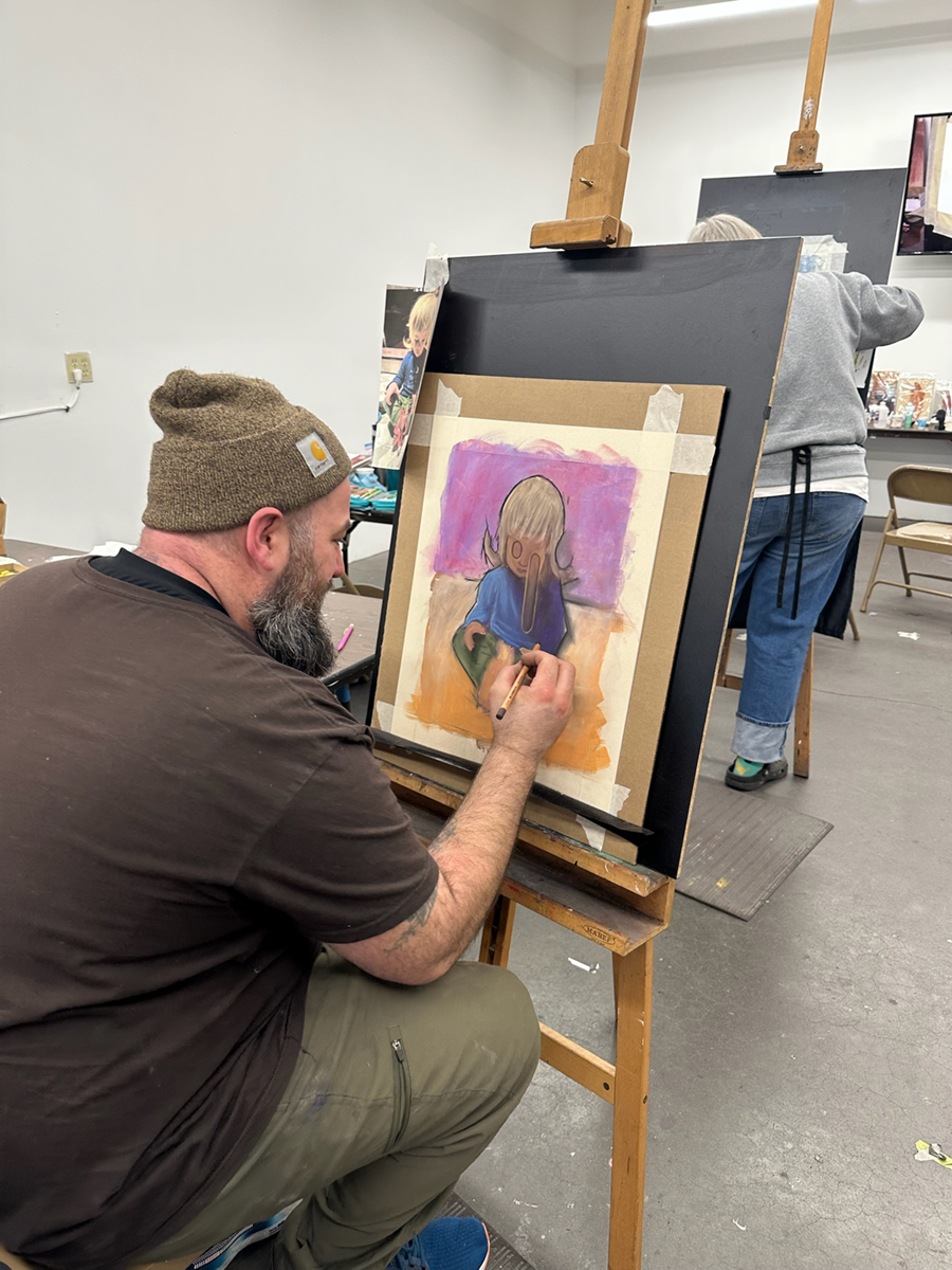 Kevin Carroll works on an oil pastel piece