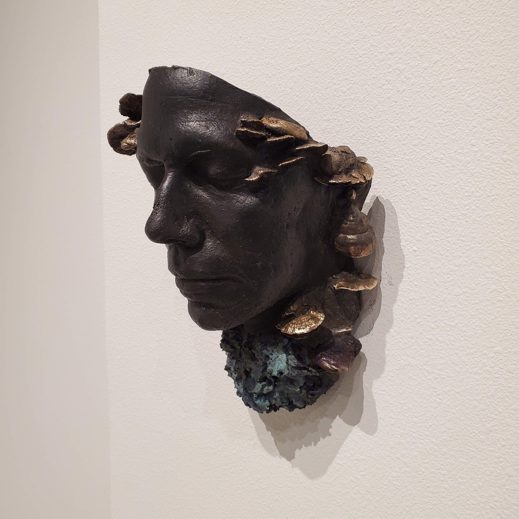Face mask with lichen and fungus cast in bronze by Christen Booth. Image courtesy of the artist