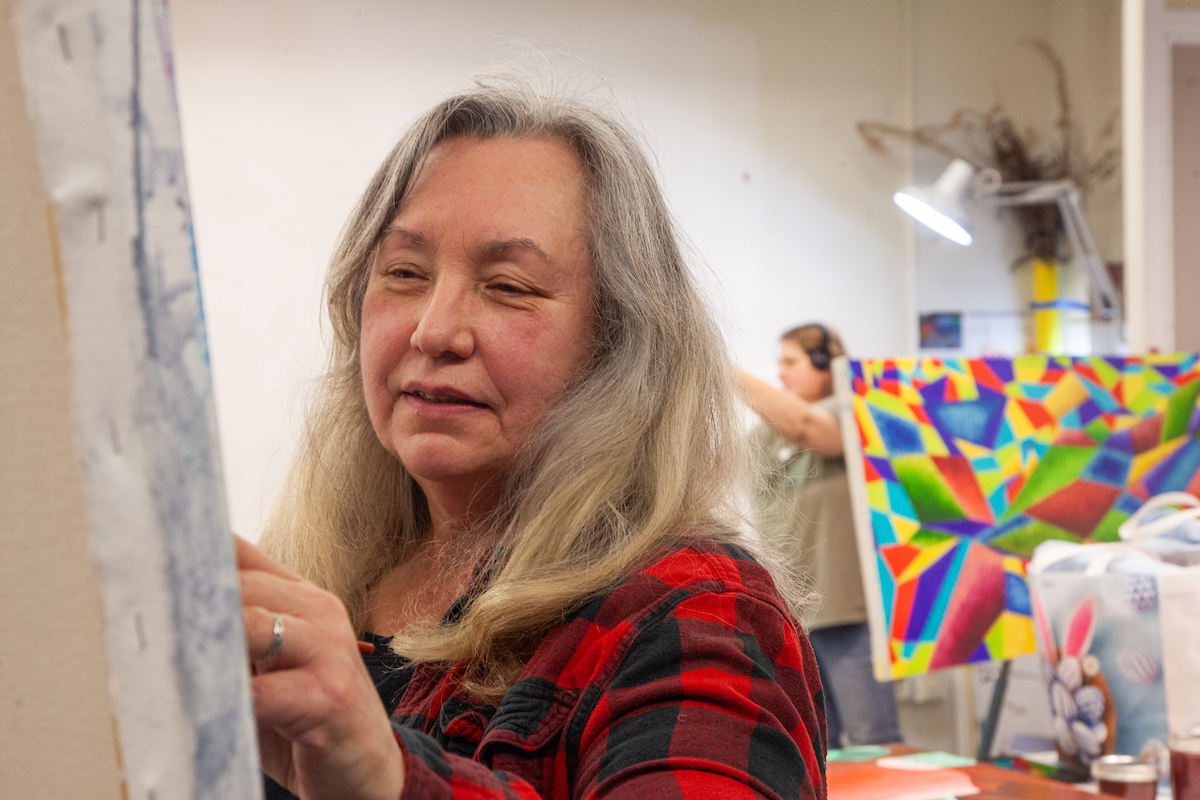 Susan Andrews works on her project in the painting studio Tuesday, Decmber 5, 2023. UAF Photo by Sydney Jolin