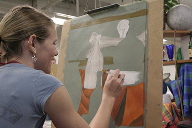 Student painting in the studio