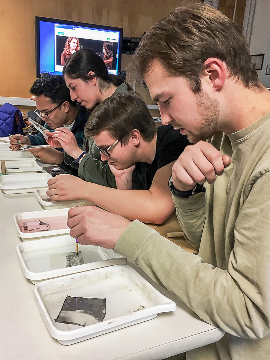 A group of students work on Polaroid transfers during a workshop. UAF photo by Kat Reichert