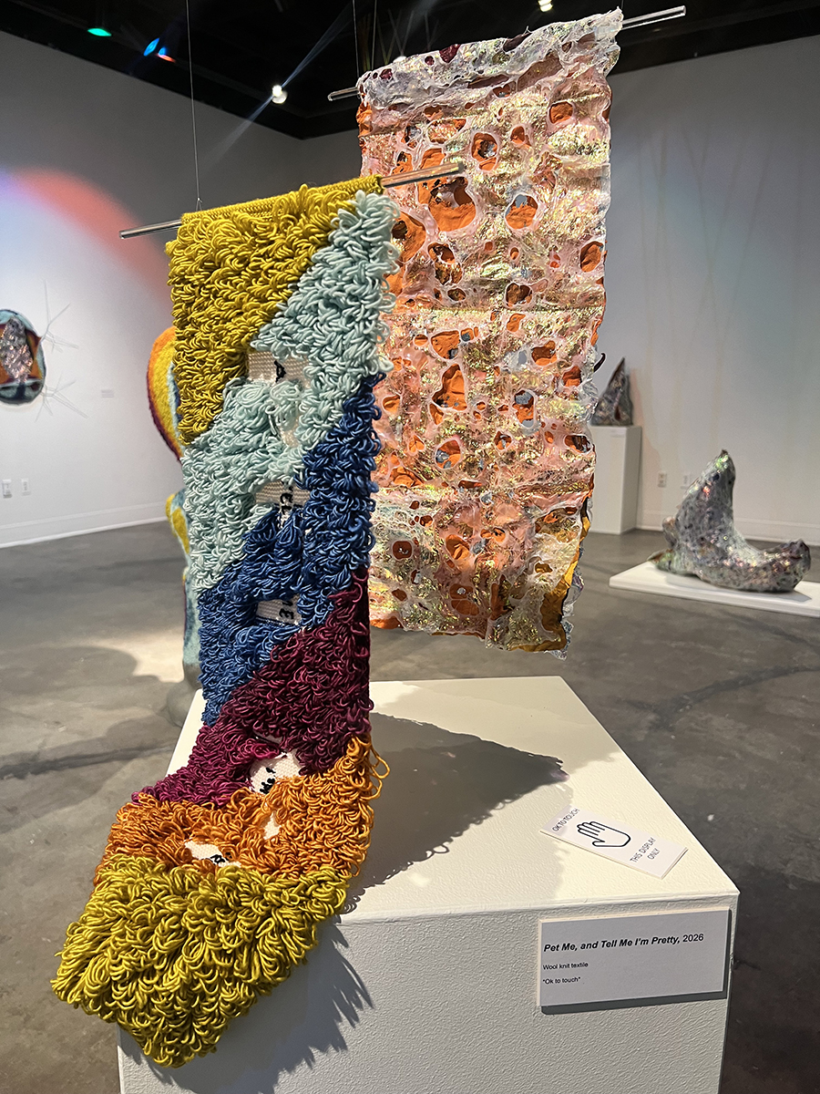 Colorful wool knit sculpture suspended in the UAF Art Gallery