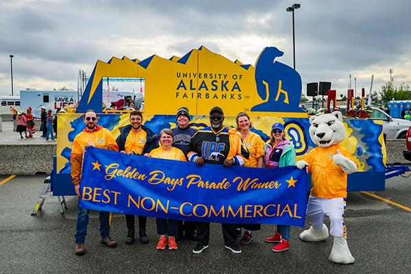 Participants of UAF's 2023 Golden Days Parade march gather for a group photo before walking through downtown Fairbanks. UAF photo by Leif Van Cise.
