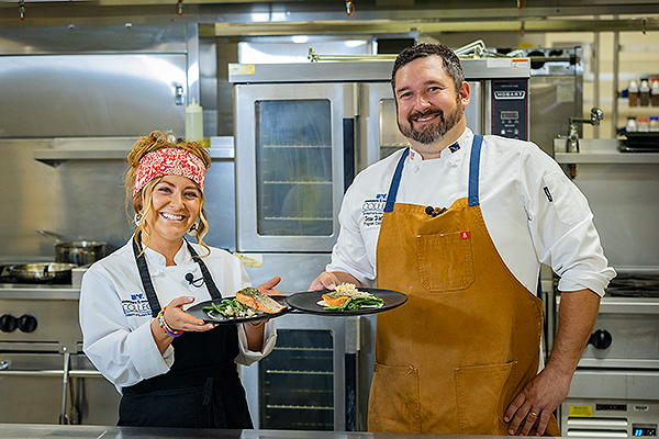 UAF photo by Leif Van Cise. Lizzie Hartman and Sean Walklin plate their final meal of the day in the UAF Community and Technical College culinary arts kitchen at the Hutchison Center on Aug. 24, 2023.