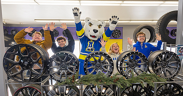 UAF students (from left) Cole Houser, Jesse Tyrrell, Lilly Varney and Jackson Nelson celebrate Giving Day with Nook at Alyeska Tire, one of this year's challenge sponsors, in March.