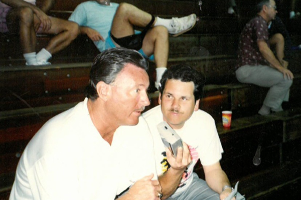 Bruce Cech interviews UAF men’s basketball head coach George Roderick at the Big Island Invitational in Hilo, Hawaii, in 1995.
