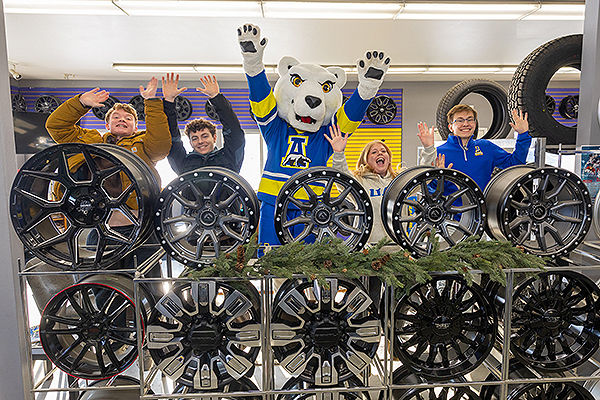 UAF students (from left) Cole Houser, Jesse Tyrrell, Lilly Varney and Jackson Nelson celebrate Giving Day with Nook at Alyeska Tire, one of this year's challenge sponsors, in March. Photo by Katie Straub. 