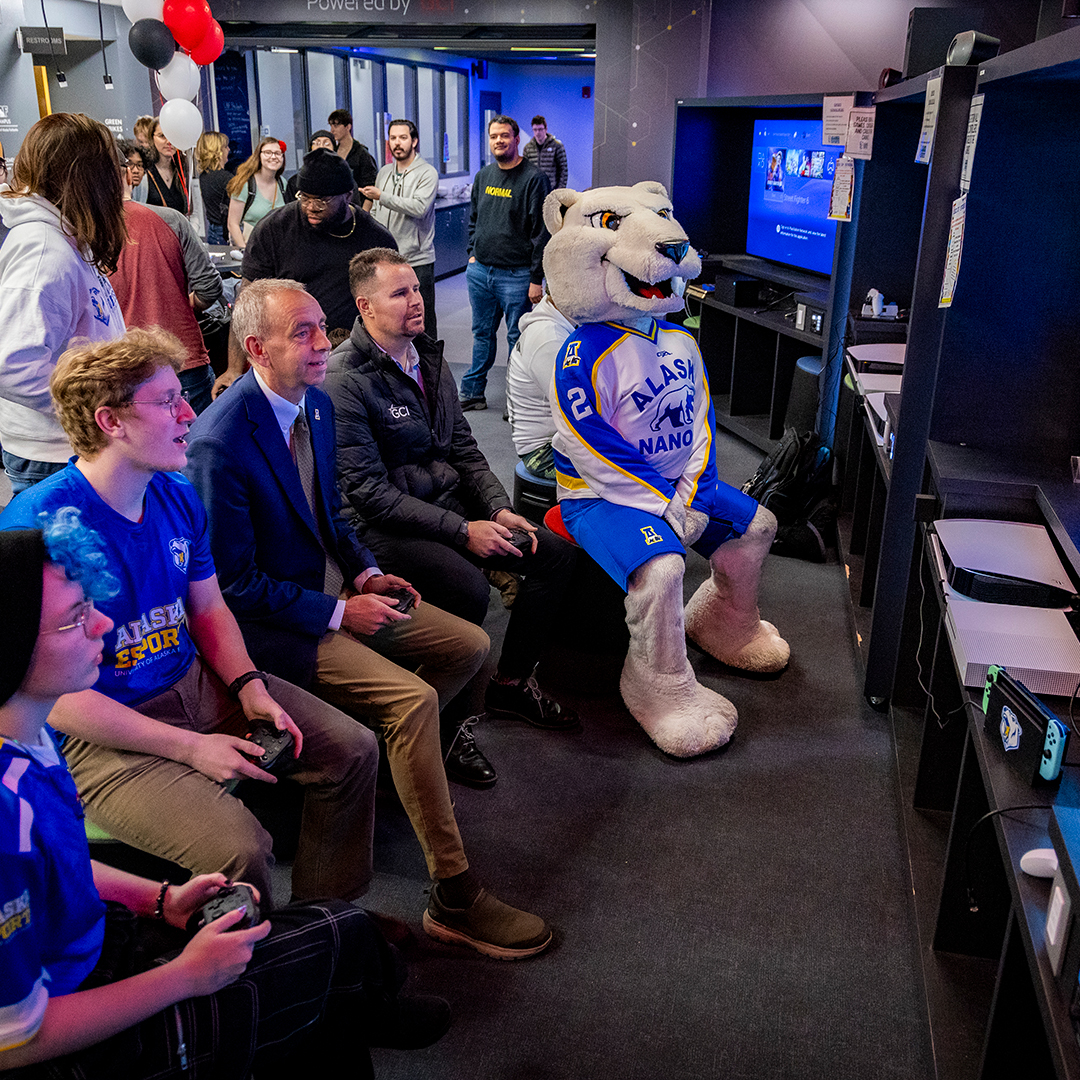 From left, UAF esports team members Natalie Lutrell and Max Beiergrohslein join Vice Chancellor Owen Guthrie and Heath Day, GCI's education program senior manager, for a Mario Kart race during a block party event to celebrate upgrades at the Alaska Esports Center on Oct. 6, 2023. UAF photo by Leif Van Cise.