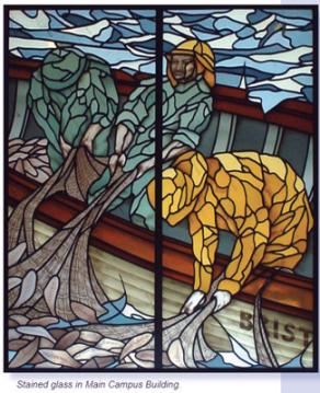 Stained glass depiction of fishermen pulling up nets