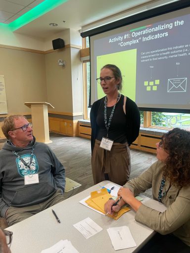 A person stands and addresses the conference. 