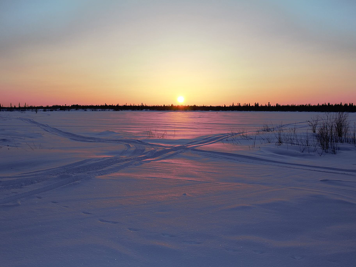 Sunset in over a snow covered field