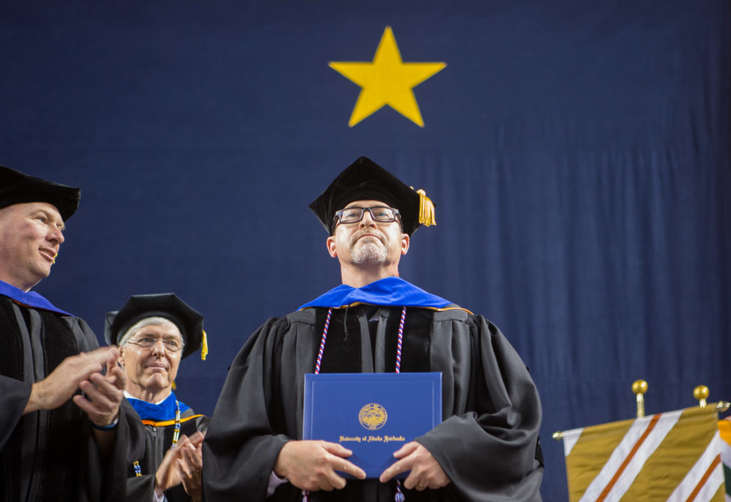 Cameron Carlson after receiving his Ph.D. at UAF Commencement 2017. Photo by Troy Bouffard.. 