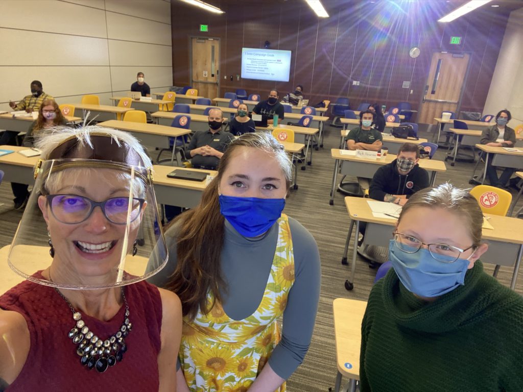 Chelsea Roehl is pictured in the middle, donning her sunflower dress