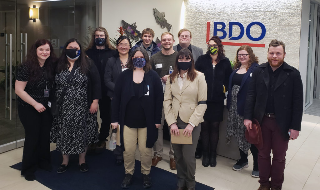 students wear masks and take group photo in the BDO lobby