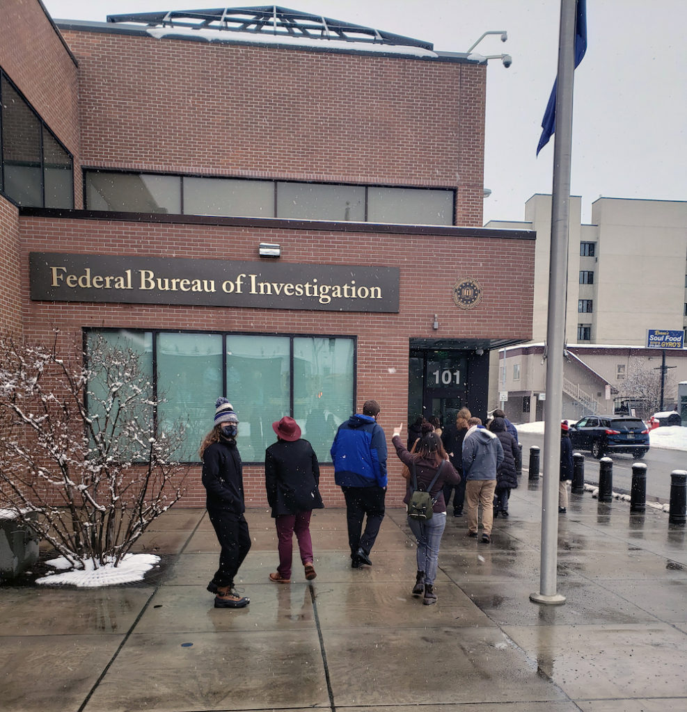 ten students walk into the Federal Bureau of Investigation building on a rainy day