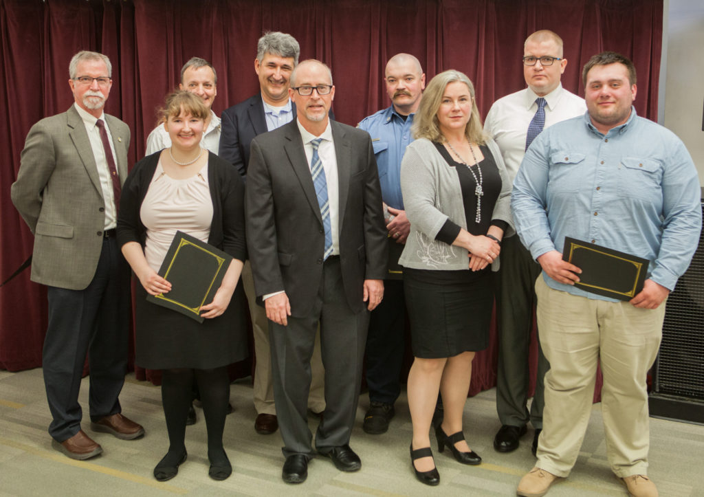 Front row (L-R): Sydney Brazeau, Cam, Katherine Janoski, James Wall; Back row (L-R): Michael Sutton, Chief Doug Schrage, Glenn Gambrell, Michael High, Antti Kettunen