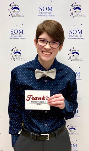 student smiles holding up Franks Menswear card