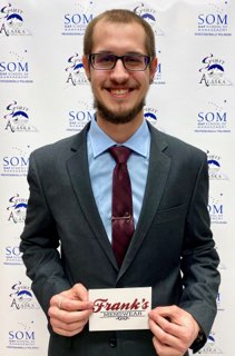 student smiles holding up Franks Menswear card