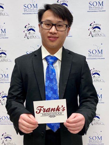 student smiles holding up Franks Menswear card