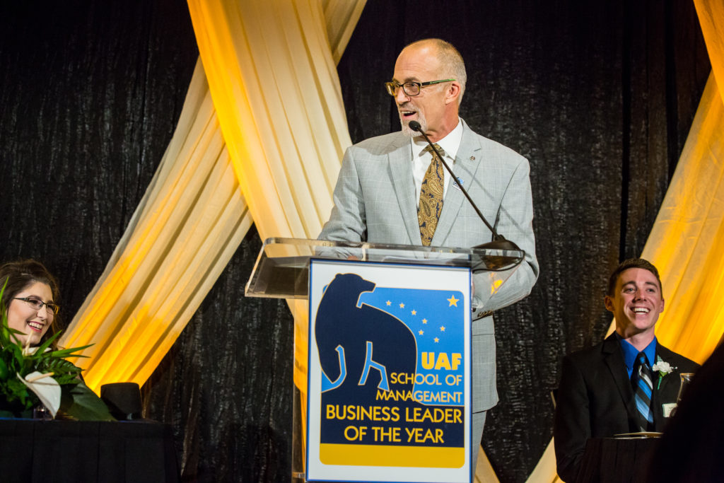 Man gives speech behind a podium