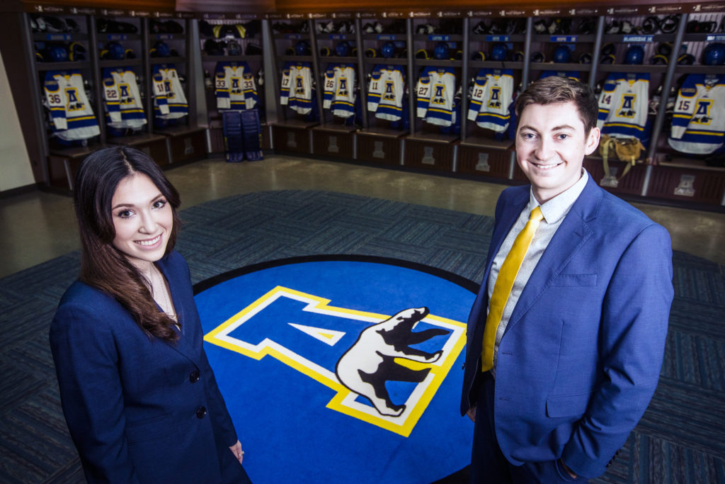UAF employees standing in the hockey locker room