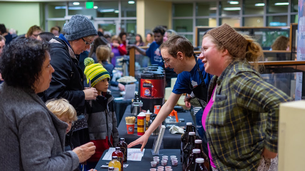 Roast and Boast partners handing out free samples of their item to the community.