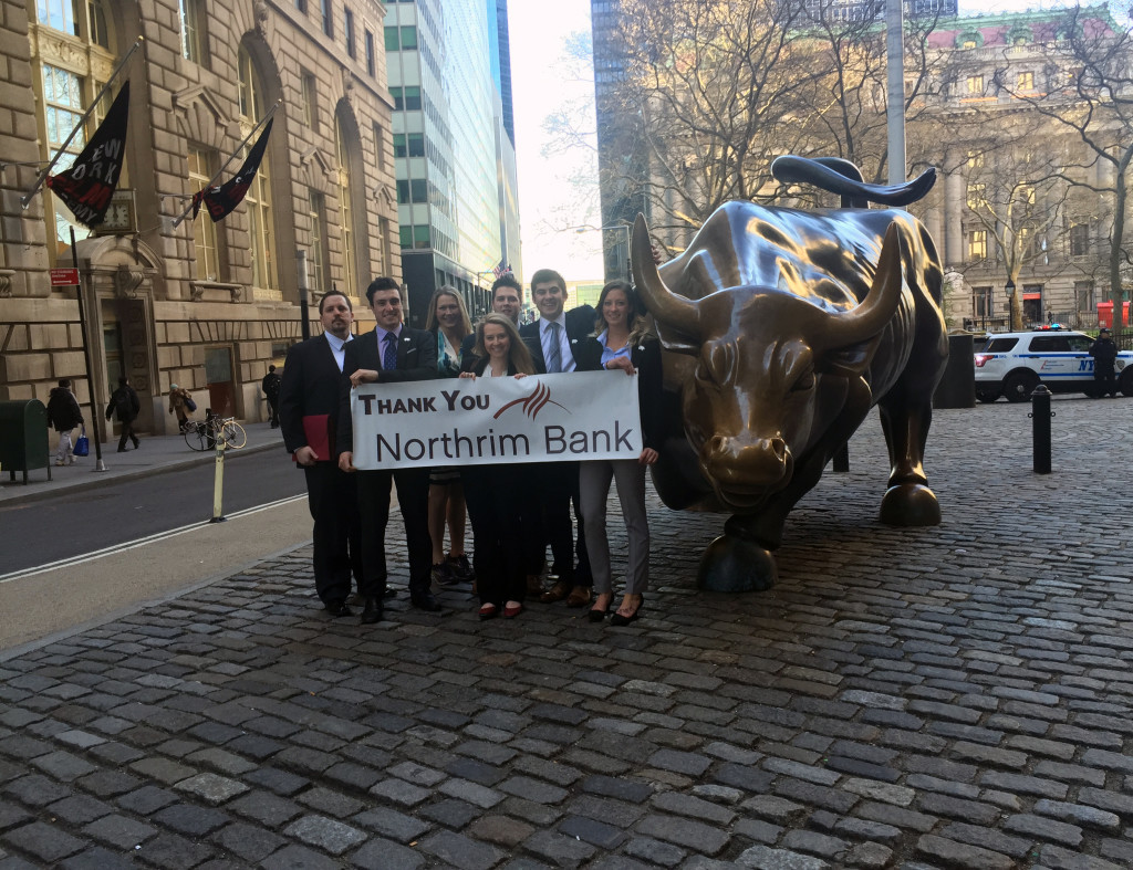 Tracy Reeves, Alec Hajdukovich, Kim McGinnis, Jamie Boyle, Hayden Nilson, Stefan Hajdukovich and Lacey Cruikshank pose with the Wall Street Bull.