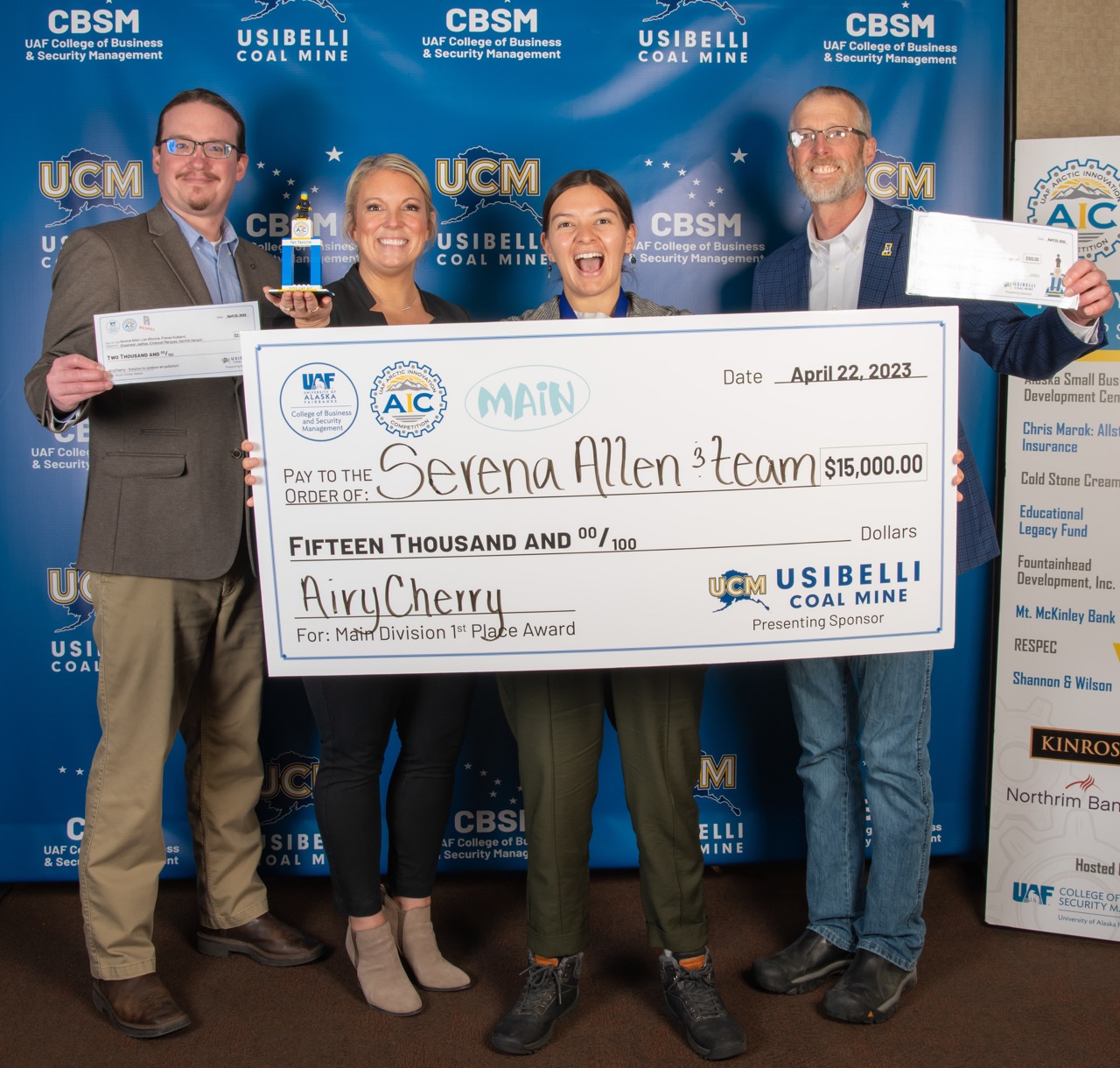 Serena Allen holds up giant check at AIC photobooth.